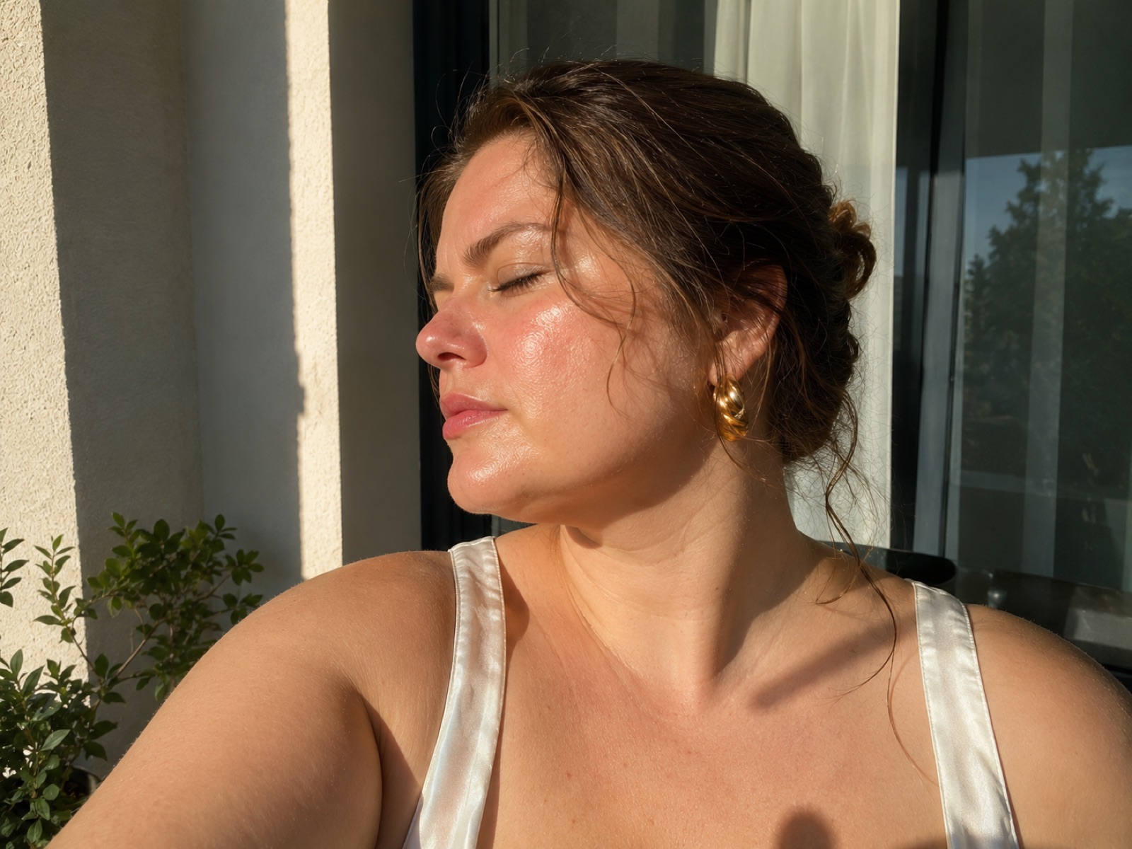 A woman with glowing skin in warm sunlight