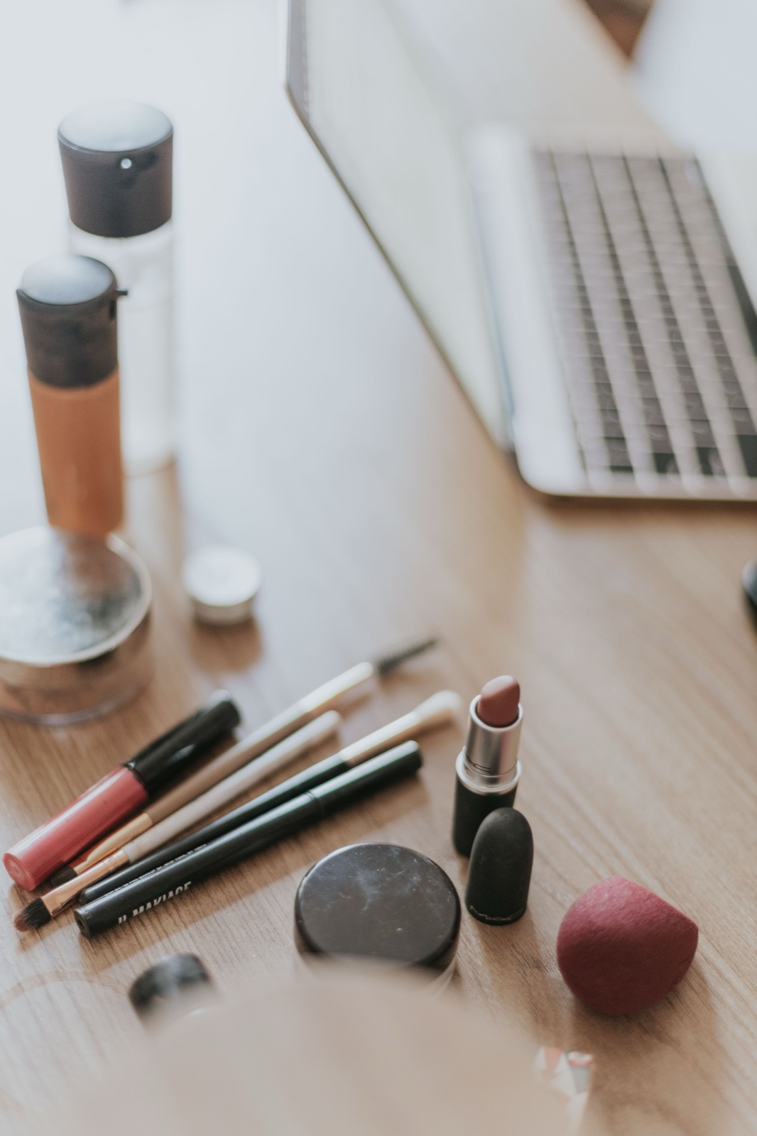 Someone fitting in their skincare at a sunny desk during a busy morning